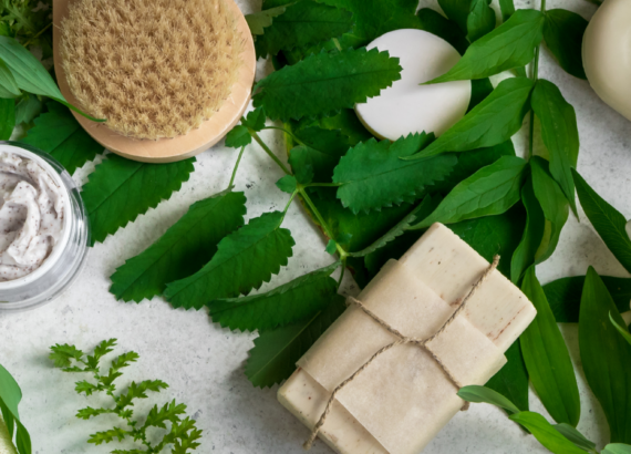 soap, brush, and skin cream styled on leaves