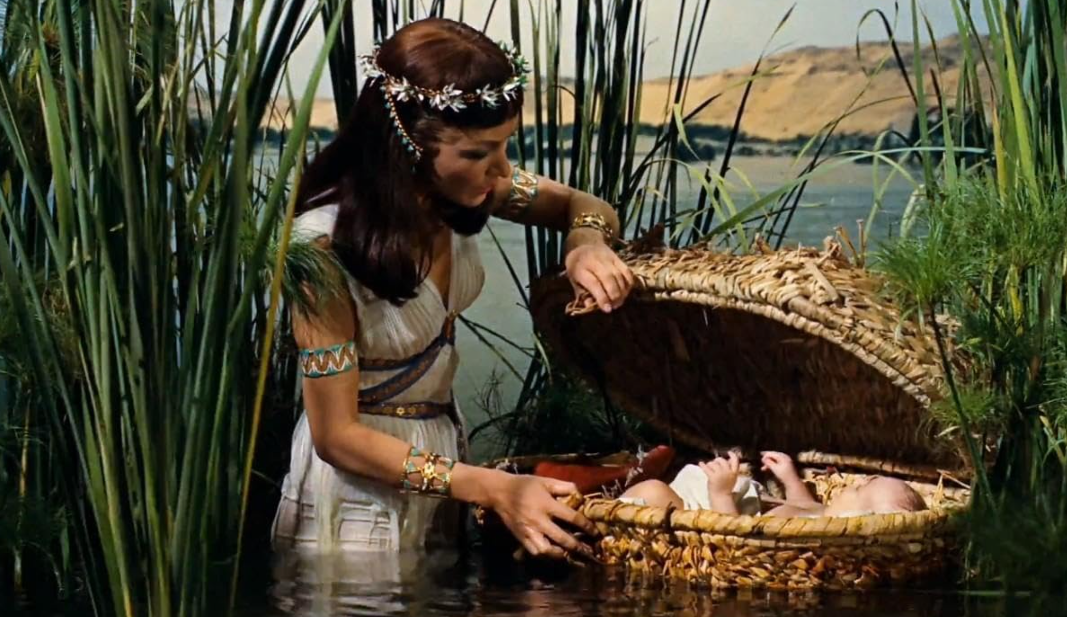 photo of a woman finding a baby in a basket from the movie the Ten Commandments 