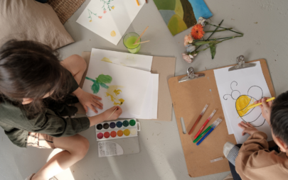 two kids coloring and painting