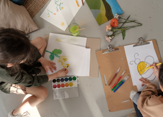 two kids coloring and painting