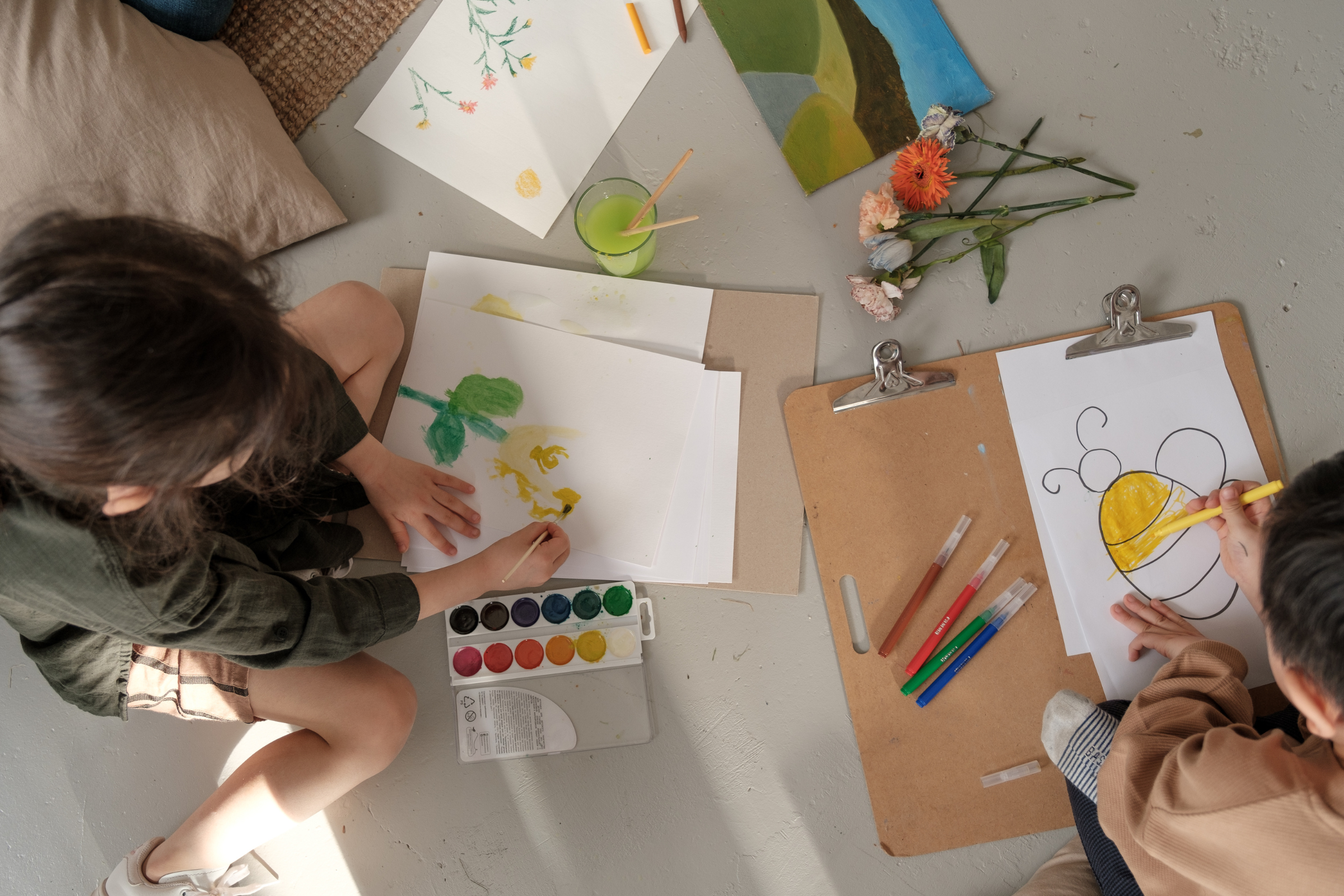 two kids coloring and painting