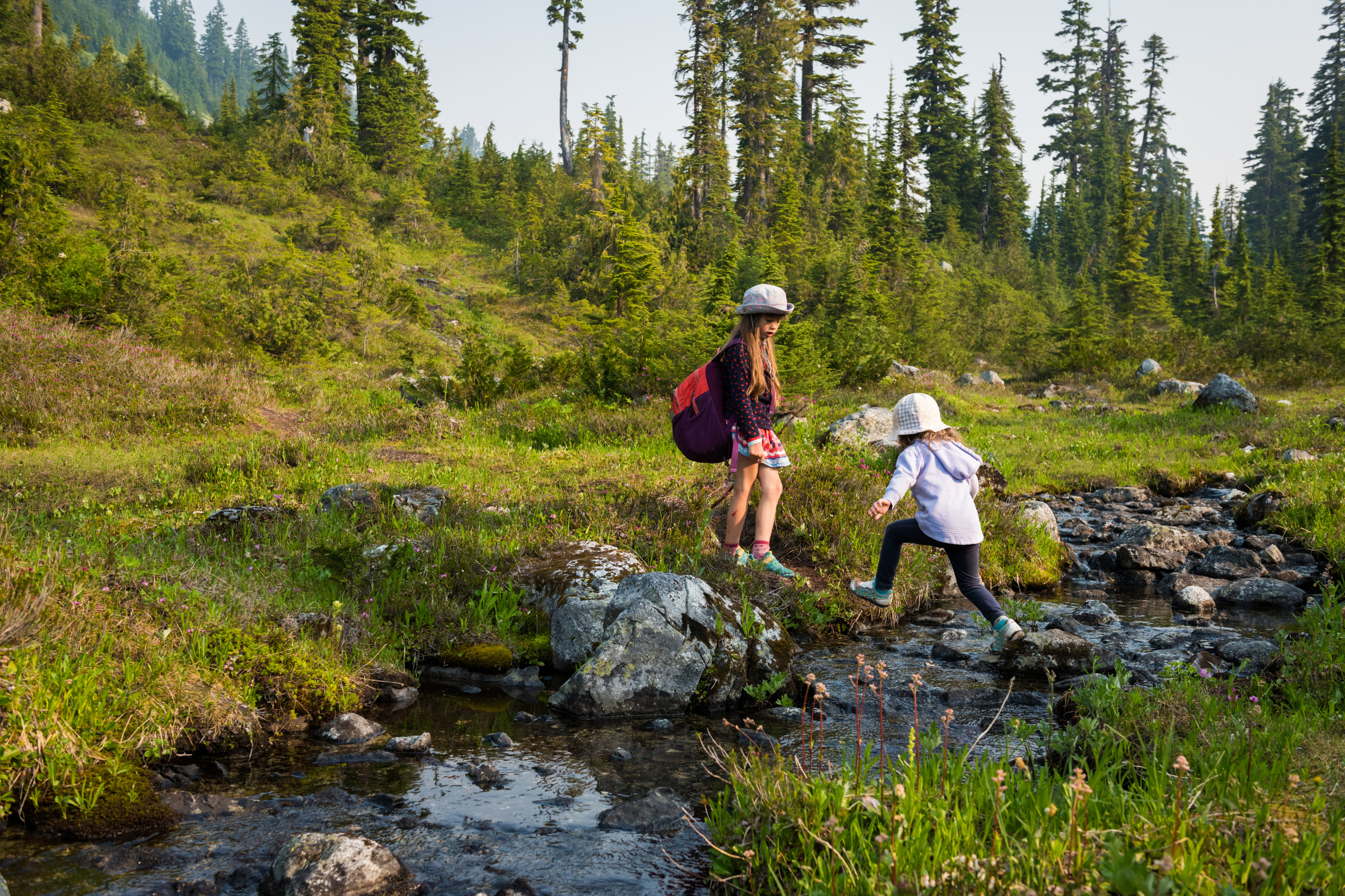 two kids hiking in the mountains