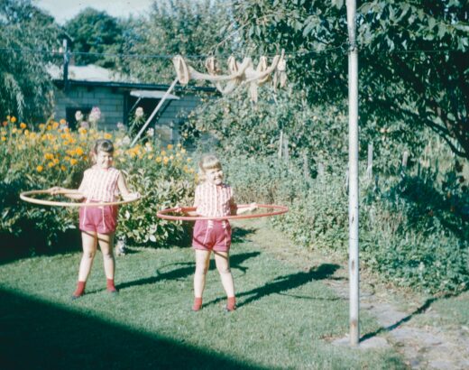 two girls hoola hooping in the back yard circa 1980 or 1990