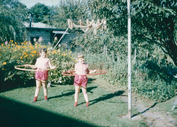 two girls hoola hooping in the back yard circa 1980 or 1990