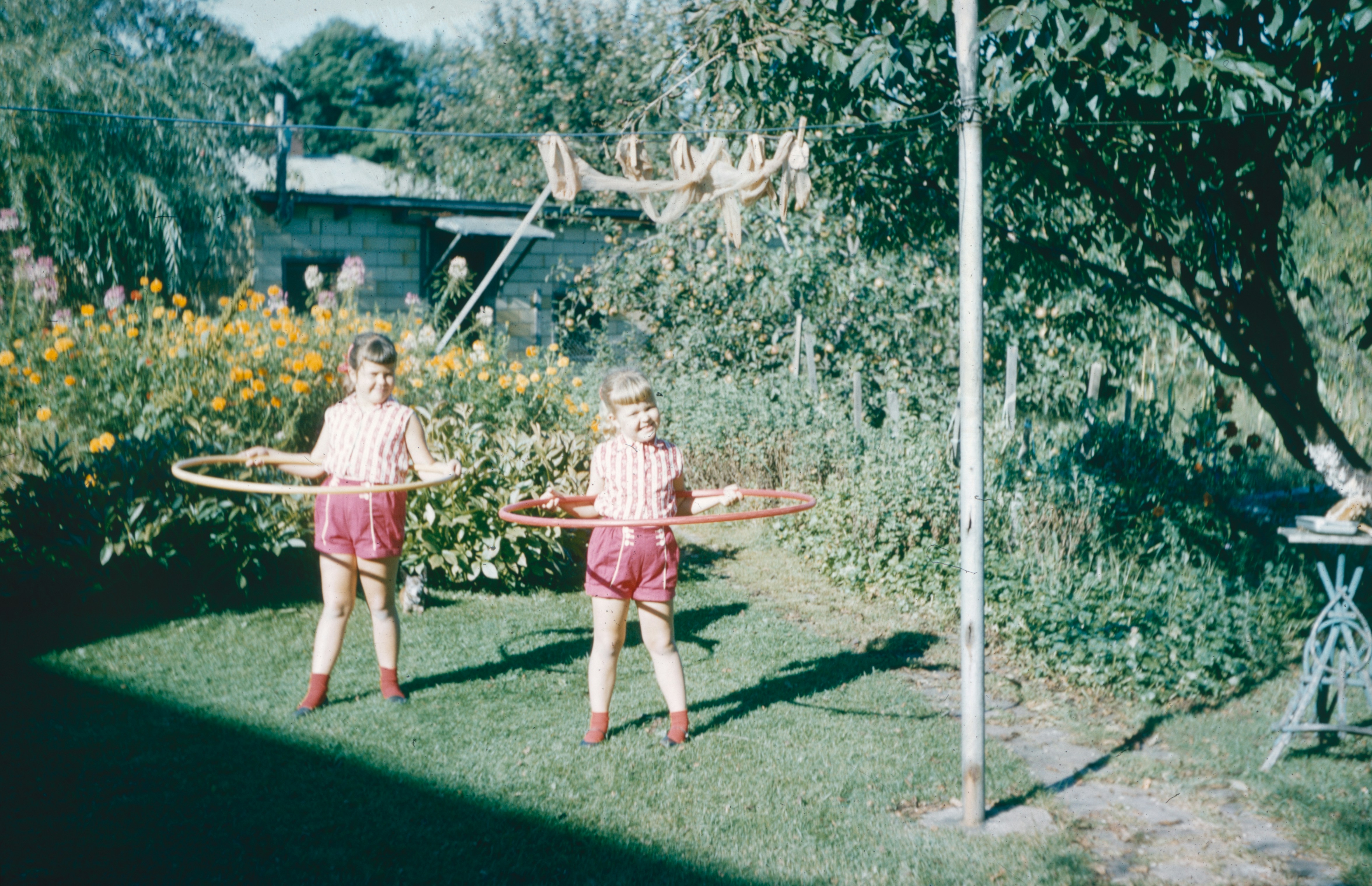 two girls hoola hooping in the back yard circa 1980 or 1990