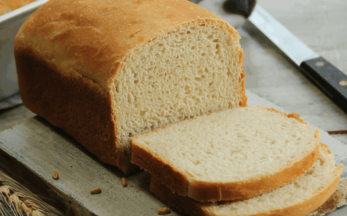 loaf of sandwich bread sliced on a table