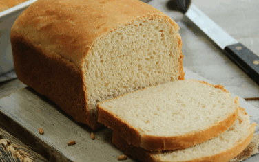 loaf of sandwich bread sliced on a table