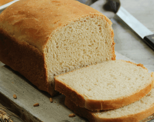 loaf of sandwich bread sliced on a table