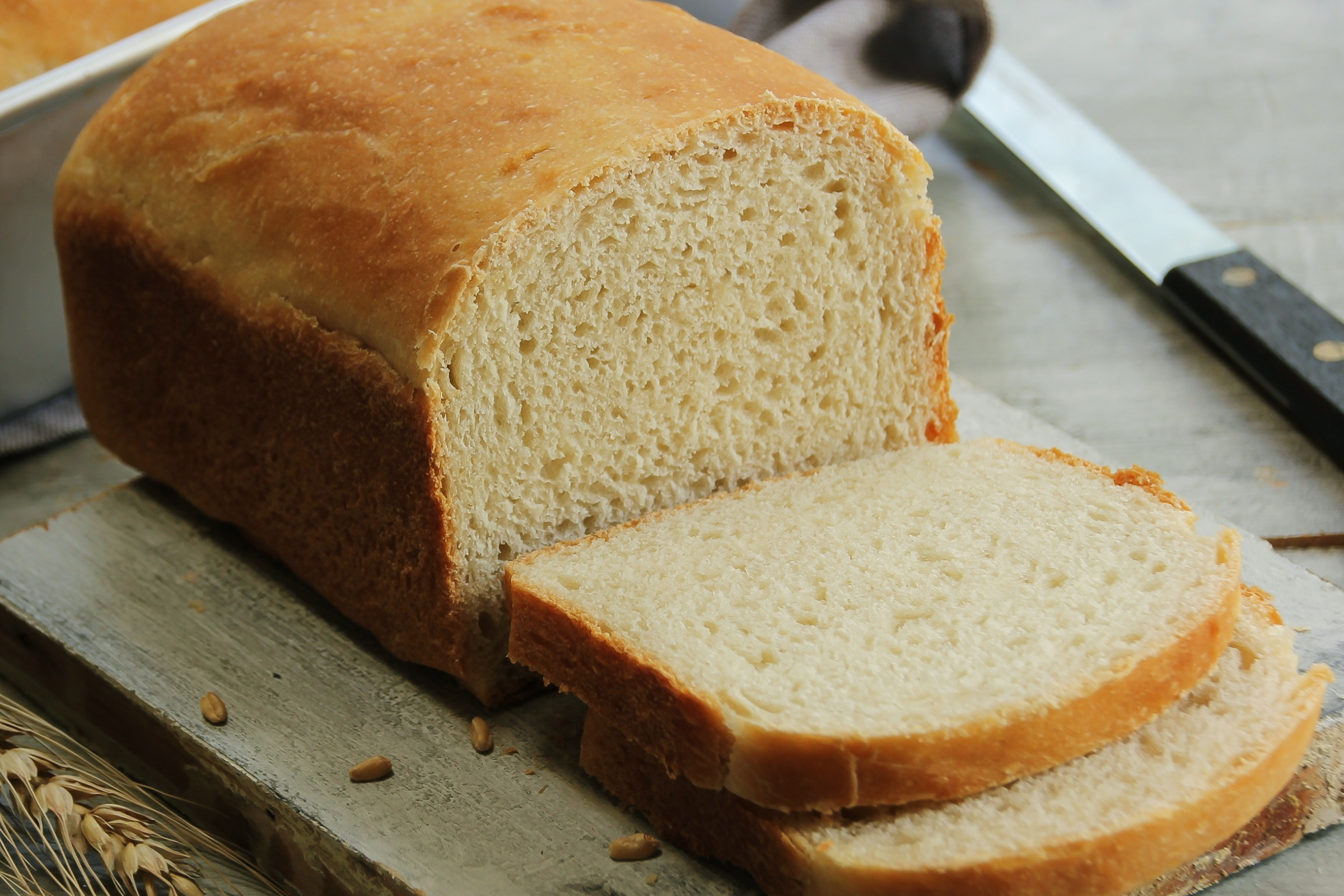loaf of sandwich bread sliced on a table